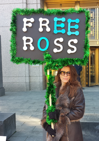 <h2>Free Ross</h2>
Michele Seven outside Federal District Court in Manhattan, January 2015.
<p>Source: <a href="https://insidebitcoins.com/news/ross-ulbricht-on-trial-protestors-defend-silk-road/28769">insidebitcoins.com</a></p>